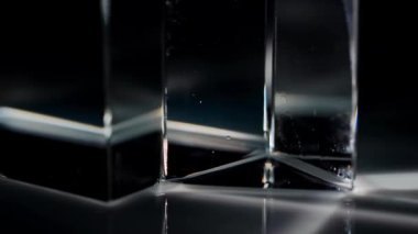 Büyüleyici bir görüntü cam prizma ile ışığın etkileşimini yakalıyor, çarpıcı kırılma desenleri sergiliyor. Macro, ağır çekim.