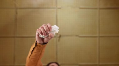 Cam masanın altındaki pamuklu çubuklardan oluşan dinamik bir düzenleme nötr bir arkaplana karşı karmaşık ve sanatsal bir görüntü oluşturur. Yavaş çekim