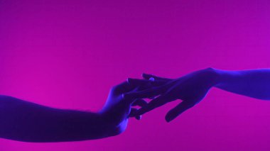 Bir el, sanatsal bir ortamda romantik bir teklifi sembolize eden neon ışıklı bir yüzük sunar..