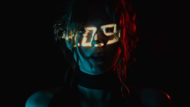 Yüzünde dijital saat projeksiyonu olan bir kadının portresi. Yaşamın geçiciliği kavramı.