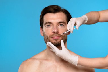 Dudak hacmini arttırma ve yüz estetiğini geliştirme amaçlı bir kozmetik dudak enjeksiyonu prosedürüne yakın çekim.