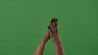 Creepy zombie hands clapping, covered in dirt and decaying skin, isolated on a green chroma key background. Perfect for Halloween party graphics, spooky decorations, and festive media design.