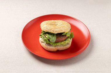 Kırmızı tabakta simit burger. Moda bir yemek. Nefis sandviç..