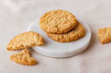 Oatmeal cookies on a marble stand. Healthy food for breakfast or a snack. Side view.