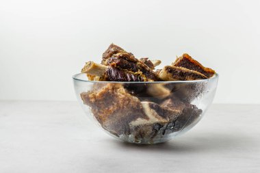 Cam kasede sığır pirzolası. Gri arkaplanda pişmiş taze kırmızı et parçaları..