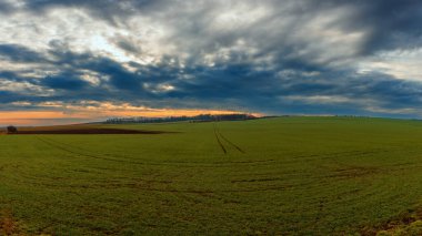 Beautiful autumn landscape in a foggy haze. Dramatic sky with beautiful clouds.