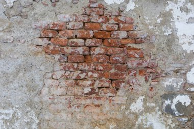 A brick wall with plaster on it.