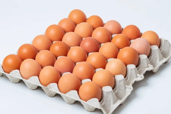 Large chicken eggs are on a paper plate. Eggs for sale. Flatlay photo.