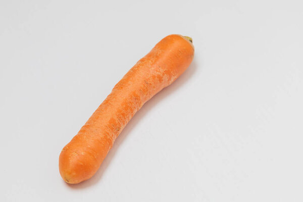 Raw unpeeled washed carrots on a white background