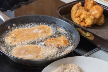 Tavada yağda kızartmak için sarılmış tavuk pirzolası..