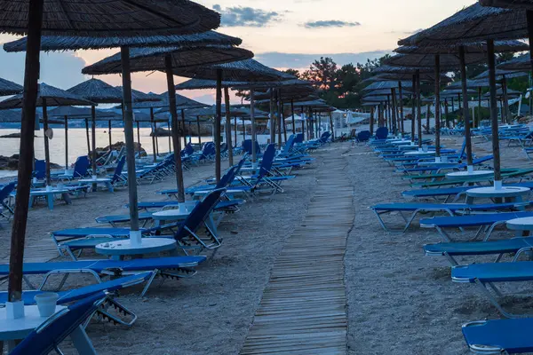 stock image Evening hotel beach on the island of Thassos in Greece. There are umbrellas and sunbeds on the beach