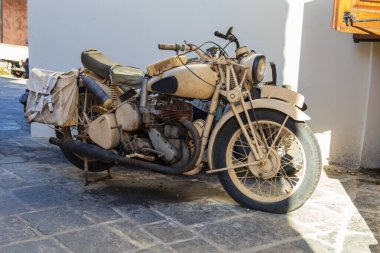 Old broken down motorbike in the streets of a Greek city clipart