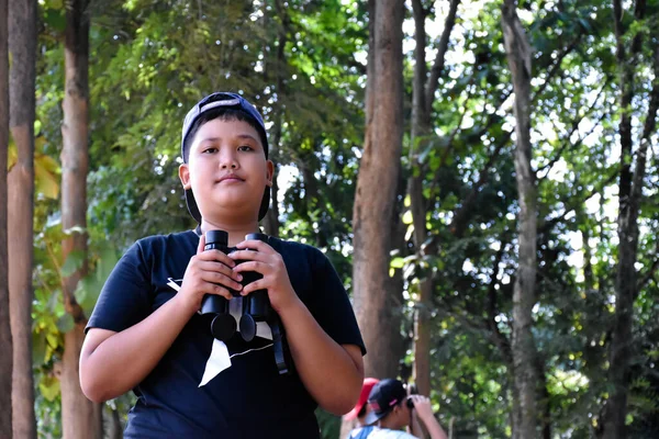 彼の友人と熱帯雨林で鳥を見るために双眼鏡を使用して肖像アジアの少年たち 教室の外の生き物や野生動物を学ぶためのアイデア ソフトフォーカス — ストック写真