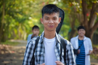 young asian teens spending freetime together along the way walking to home after music lesson at school, young adult asian couple concept.