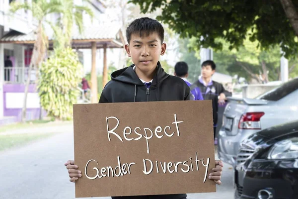 Asian boy holds brown protesting paper which has texts \
