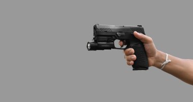Isolated automatic 9mm pistol gun holding in right hand with clipping paths. concept for using pistol to protect properties and humans in crisis situations around the world.