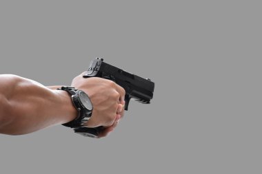 Isolated automatic 9mm pistol gun holding in right hand with clipping paths. concept for using pistol to protect properties and humans in crisis situations around the world.