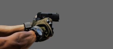 Isolated automatic 9mm pistol gun holding in right hand with clipping paths. concept for using pistol to protect properties and humans in crisis situations around the world.