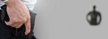 Isolated automatic 9mm pistol gun holding in right hand with clipping paths. concept for using pistol to protect properties and humans in crisis situations around the world.