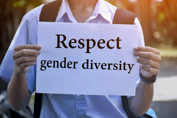 Asian boy in school uniform holds white paper which has texts 'Respect Gender Diversity', concept for calling out all people around the world to support and respect human rights in gender selecting.