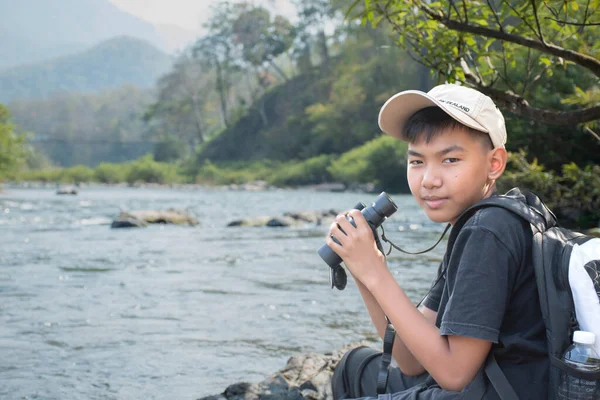 Asian Boy Plaid Shirt Wears Cap Has Backpack Holding Binoculars — Stockfoto