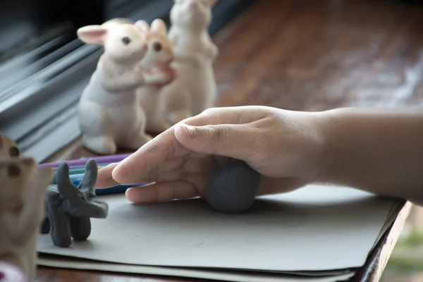 stock image An autistic boy molding different shapes of colored plasticine prepared by parents at home in order to develop various aspects in their son which has slower brain development than normal children.