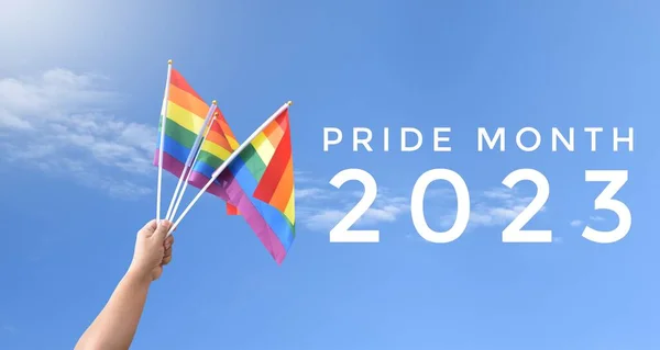 stock image 'Pride Month 2023' on blurred rainbow flag raising background, concept for LGBT people celebrations in pride month, june, around the world.