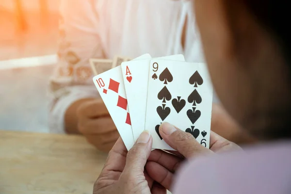 stock image Retired people playing card in a retirement home, happiness of elderly people after retirement by playing card at home.