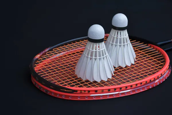 Cream white badminton shuttlecock and racket on floor in indoor badminton court, copy space, new edited, concept for endurance sports for healthy living.