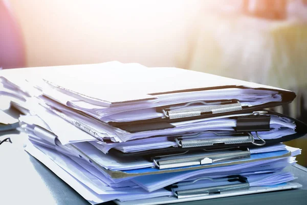 Stack of documents on table of secretary, sunlight edited, soft and selective focus.