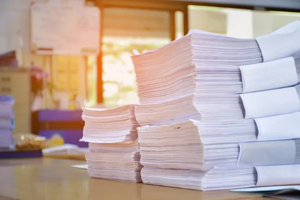 Stacks of papers, which are registration documents and data collection documents, to be distributed to staff and students on the first day of school.
