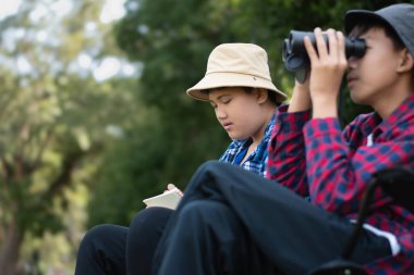 Asyalı çocuklar parklarındaki kuşları dürbünle izleyerek rahatlıyorlar..