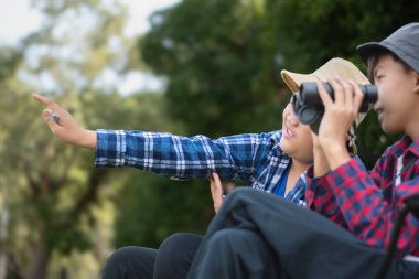 Asyalı çocuklar parklarındaki kuşları dürbünle izleyerek rahatlıyorlar..