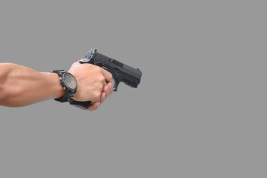 9 mm 'lik izole bir tabanca. Kesme yolları olan bir nişancının sağ elinde duruyor..