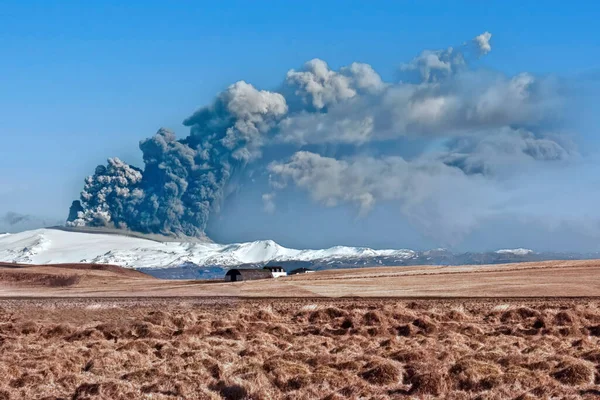 Eruption of the Eyjafjallajokull volcano in Iceland seen from a plain.
