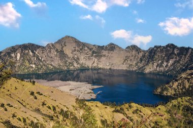 Mount Rinjani or Gunung Barujari volcano on the island of Lombok in the Segara Anak crater lake. All in the caldera created by the eruption of Mount Samalas in 1257. Indonesia clipart