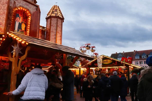 Stock image Hanau, Germany - December 15, 2019: People and buildings at a Christmas market with a ride in the background on a cloudy day in Hanau, Germany.