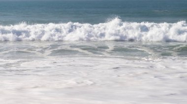 Wave in the Atlantic Ocean on a beach near Lisbon, Portugal on a warm winter day.