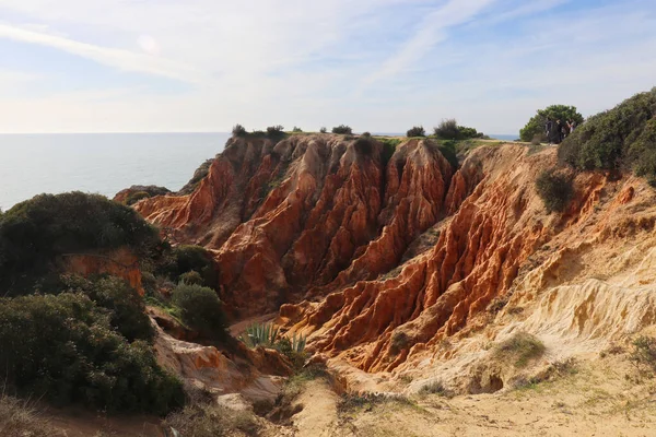 Stock image Orange limestone cliffs next to the Atlantic Ocean on the Seven Hanging Valleys hiking trail in Algarve, Portugal.