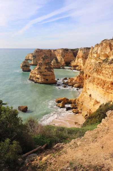 stock image Small beach surrounded by limestone cliffs along the Seven Hanging Valleys Trail in Algarve, Portugal on a winter day.