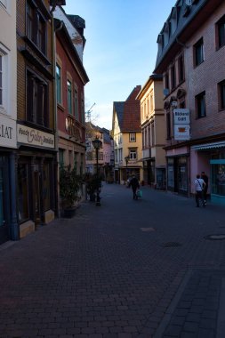 Bad Kreuznach, Germany - April 25, 2021: Cobblestone shopping area with historic buildings on a spring evening in Bad Kreuznach, Germany.