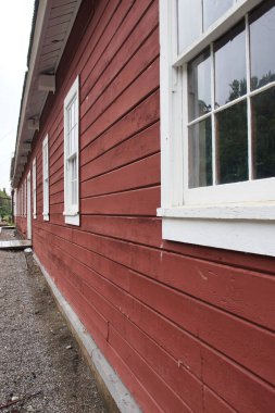 Kennecott, Alaska - July 13, 2023: Side of a red building at Kennecott copper mine in Wrangell-St. Elias National Park and Preserve in Alaska. clipart