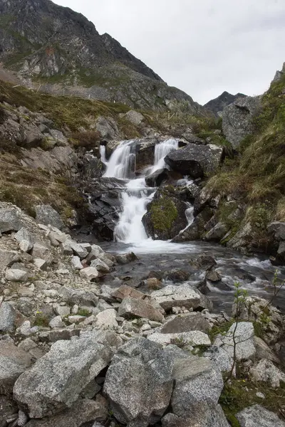 stock image Small waterfall at the abandoned Independence Mine in Alaska on a cloudy summer day.