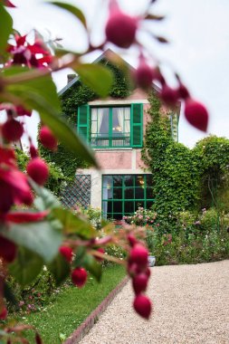 Giverny, Fransa - 23 Haziran 2021: Fransa 'nın Giverny şehrinde bir yaz günü Monet' nin evinin önünde asılı duran çiçekler.