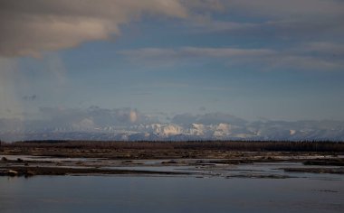 Mountains behind Salcha River in Salcha, Alaska on a spring evening.