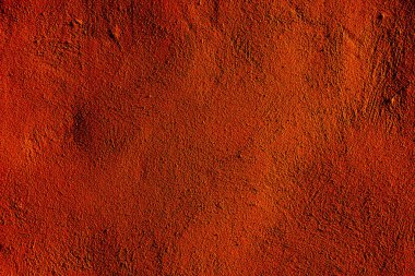 Turuncu desenli duvar yüzeyi tasarım ve yaratıcı projeler için sanatsal bir zemin sağlıyor. Sanatsal uygulamalar ya da arkaplan için mükemmel.