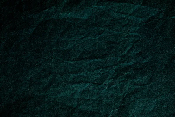 Smooth dark green crumpled paper background texture