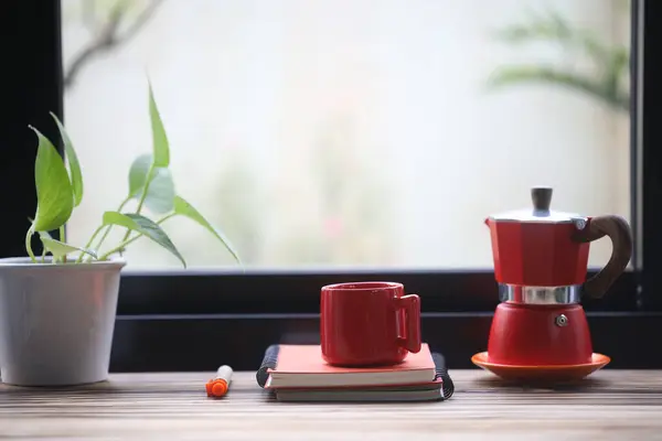 Red coffee cup and red moka pot with red notebook