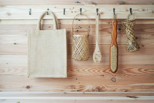 stock image organic Eco friendly canvas bag, brush,basket hanging on brown wooden wall