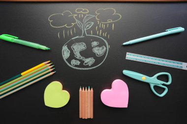 earth doodle with stationery on black chalkboard clipart